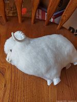 Side profile of ram showing wool covering and hooves