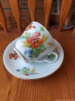 teacup resting on saucer showing main floral design