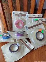 All six sealed ribbon packages on table and chair