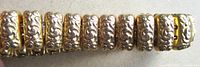 close-up of ornate floral engraved links