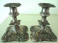 Front view of both ornate silverplate candlesticks
