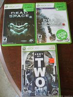 Group shot of the three Xbox 360 game cases