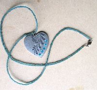 Full view of beaded necklace with heart pendant