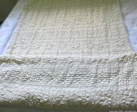 Folded ivory embossed fabric laid flat