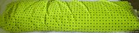 Full roll of neon lime green fabric showing length bundled