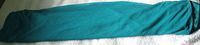 Folded length of deep aqua fabric on white surface