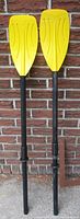 Full view of both assembled oars leaning against wall
