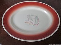 Full view of oval platter showing rim colour and centre motif
