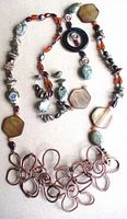 Full view of copper wire floral centerpiece and beaded strand