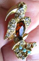 Front view showing amber marquise stone, clear rhinestones, turquoise cabochons