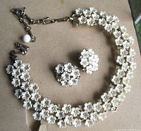 Necklace and earrings laid out showing overall design