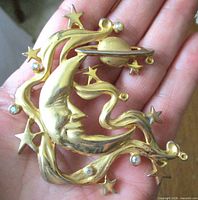 Front view showing crescent moon, stars, Saturn and rhinestones