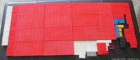 Overall view showing assembled field of red, white and assorted vintage Lego plates