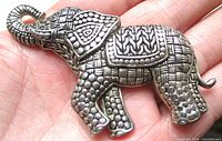 Front view of silvertone elephant brooch displaying textured design