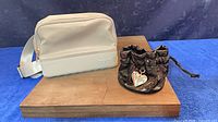 Bogg waist bag and Guess pouch on display