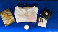 All items laid out: chemise folded center, CDs, journal, balm