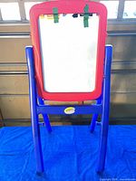 Front view whiteboard side with blue stand and red frame