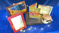 Overall lot view with frames, CD set, candle and fairy lights