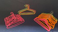 Group view of mixed neon plastic and velvet hangers
