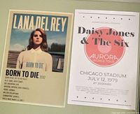 Both posters side by side on flat surface