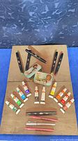 Overall view of paint tubes, markers and Bob Ross tins on board