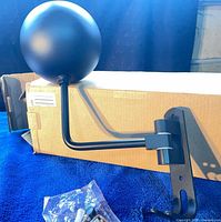 helmet hanger showing spherical rest, arm, wall plate