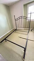 Full view of wrought iron headboard attached to adjustable metal frame