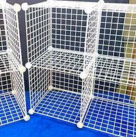 Front angled view of assembled 6-cube white wire organizer showing grid structure and connectors