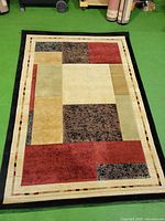 Front view of full rug showing geometric block pattern and borders