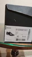 Box label showing brand, model code 61004401001, colour black, size EU 43 / US 9-9.5