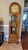 Full view of the longcase clock showing overall design and proportions