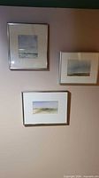 Frontal shot showing three framed watercolour prairie scenes on wall