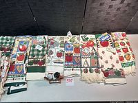 Row of apple-themed towels showing patterns and tags
