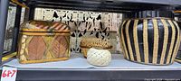 Group shot of trunk, planter, baskets and woven ball