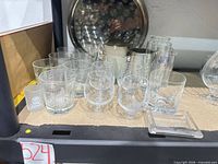 Assorted glassware, trays, stein and tankard on shelf