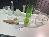 Group shot of all assorted vases, bottles, bowls, tray and pestle on tabletop