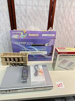 Avayon DVD player with remote, cables, manual, cardboard insert, and boxed Unisonic answering machine