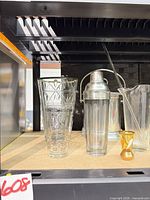 Group shot showing mixing glass, cocktail shaker, cut-style pitcher/vase and shot glass