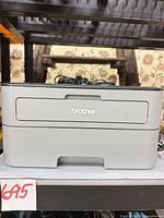 Front view of Brother HL-L2300D printer on shelf