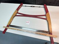 Top view of bow saw with yardstick, showing full frame, blade, and size