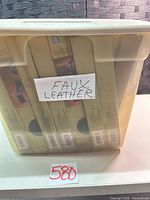 Plastic tote containing CS faux leather sample boxes
