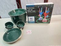 Overview of bucket, bowls, mugs and boxed game