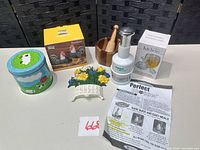 Group shot of all items: boxed rooster shakers, food chopper with instructions, wooden mortar & pestle, floral plaque, sheep tin