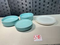 Stacked set showing all ten pieces: four bowls, four small plates, two patterned plates