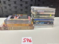 Full stack of DVDs and boxed sets on table