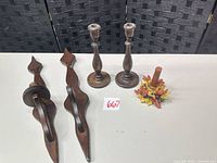 All five pieces laid out: two wall sconces, two candlesticks, one floral holder