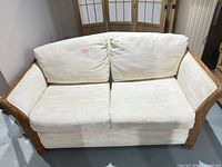 Front view of rattan wicker loveseat with cushions
