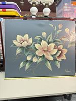 Full front view of floral acrylic painting on grey background