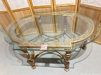 Full view of glass top and ornate gilded base