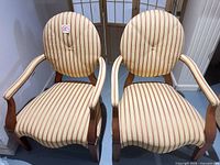 Front view of pair of striped armchairs